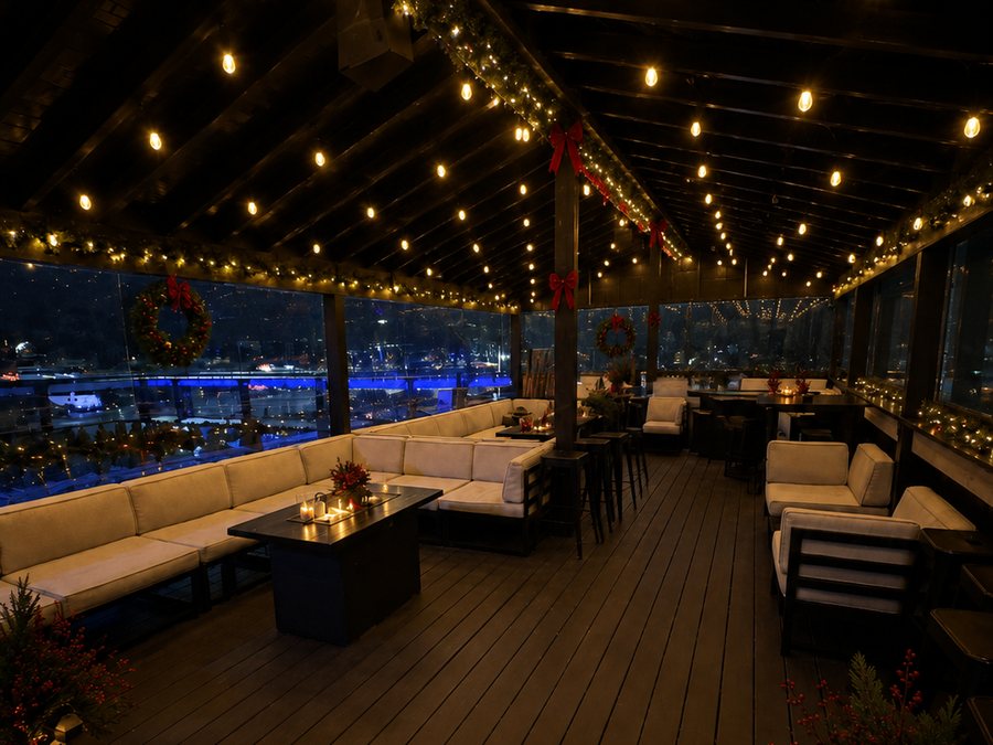 The deck lounge under string lights and garland, with patio seating