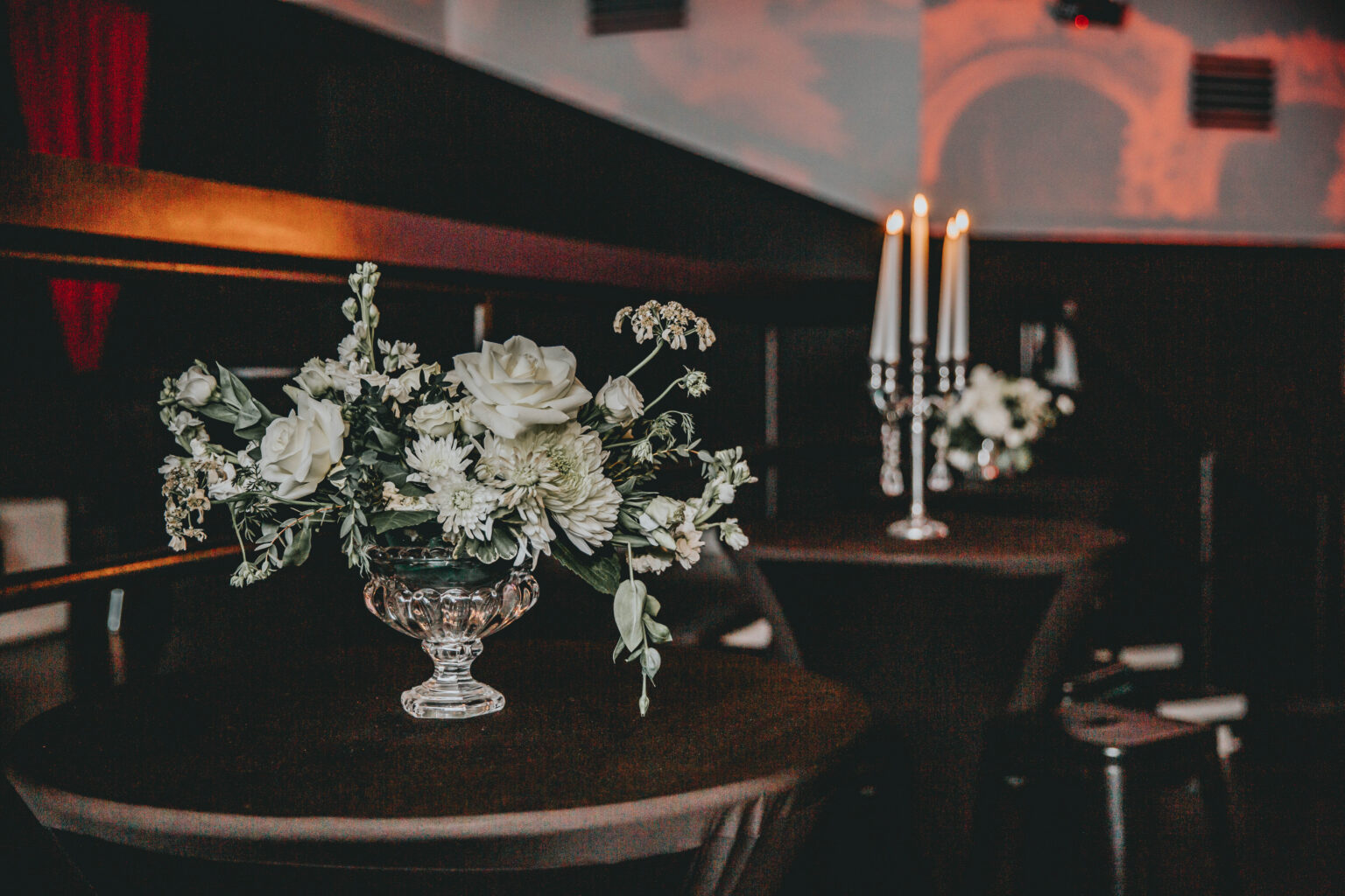 Candlelit reception tables with white florals