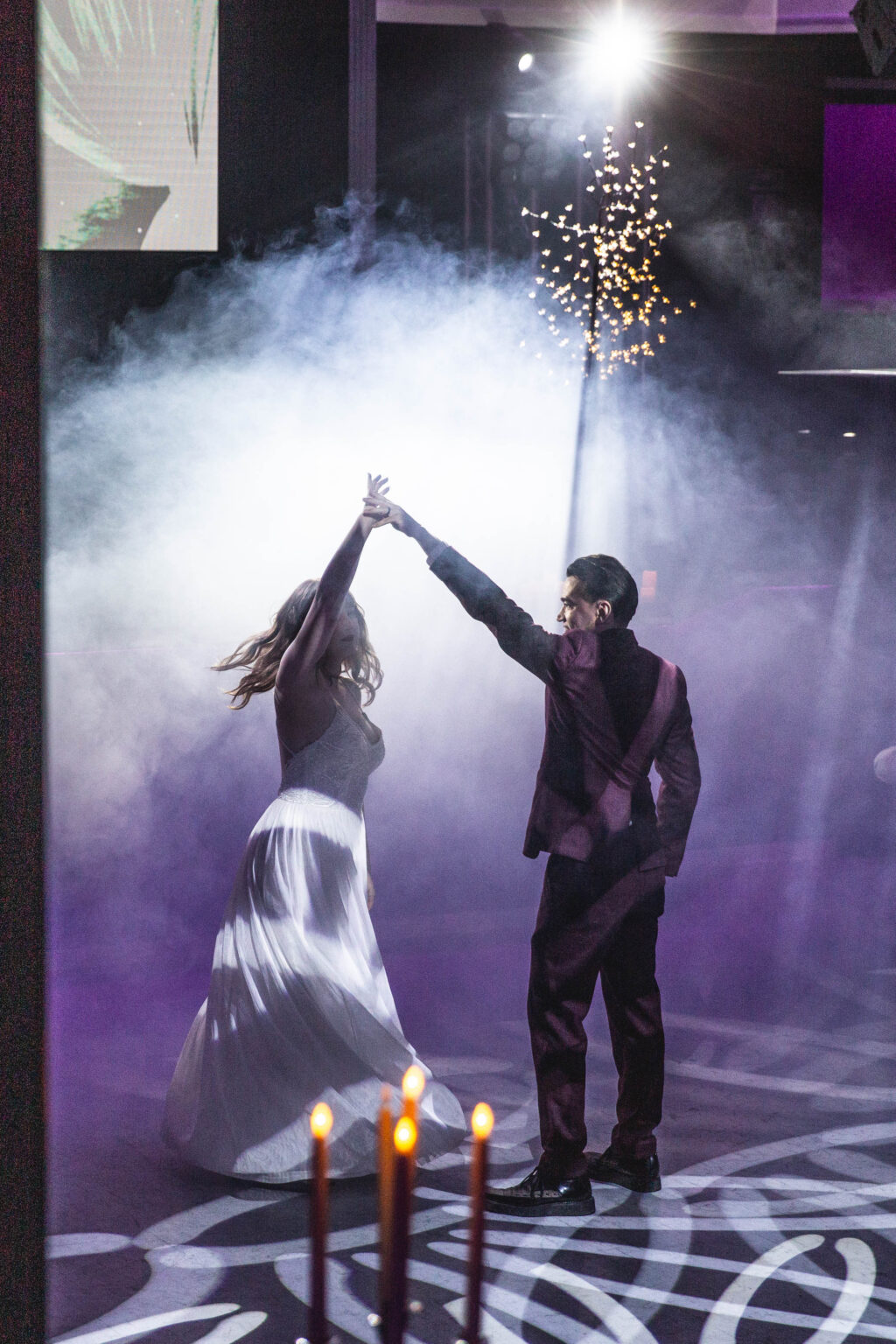 Couple sharing a first dance under the lights