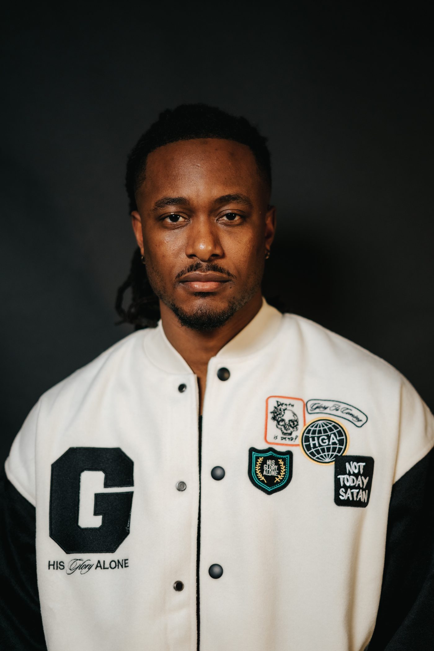 KB in the His Glory Alone varsity jacket