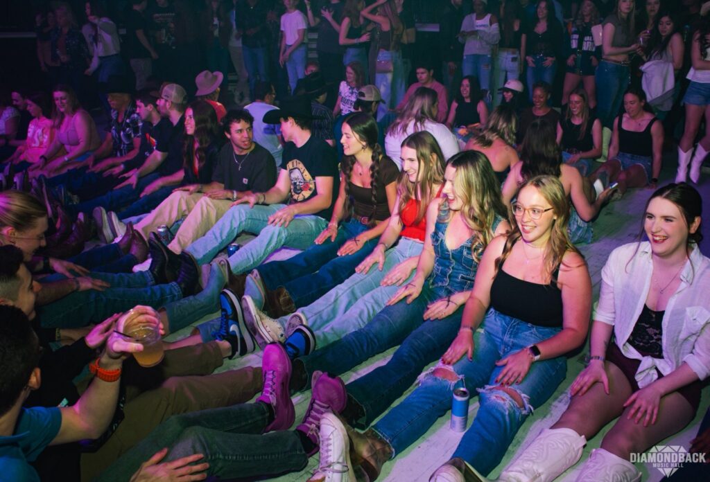 Crowd sitting on the main floor during a line dance night at Diamondback Music Hall