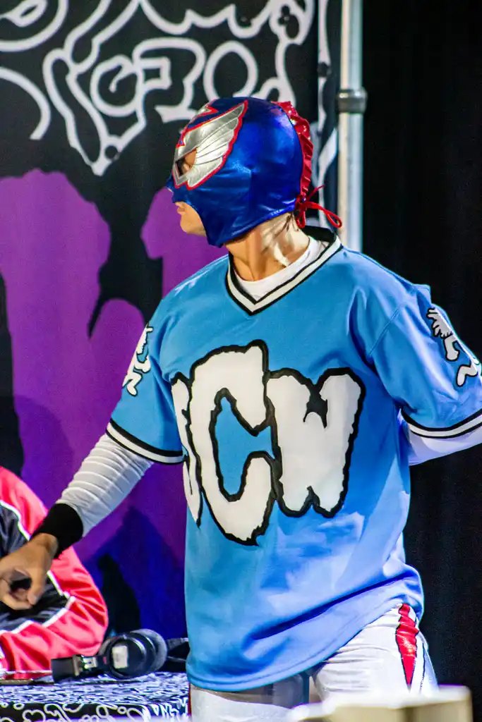 Masked luchador in a JCW jersey