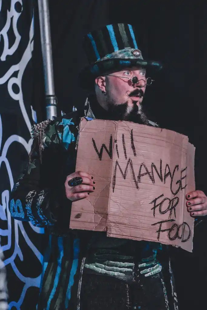 Wild character holding a will manage for food sign