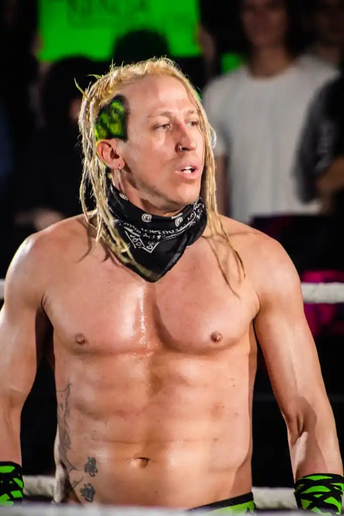 Wrestler with a bandana and green gear
