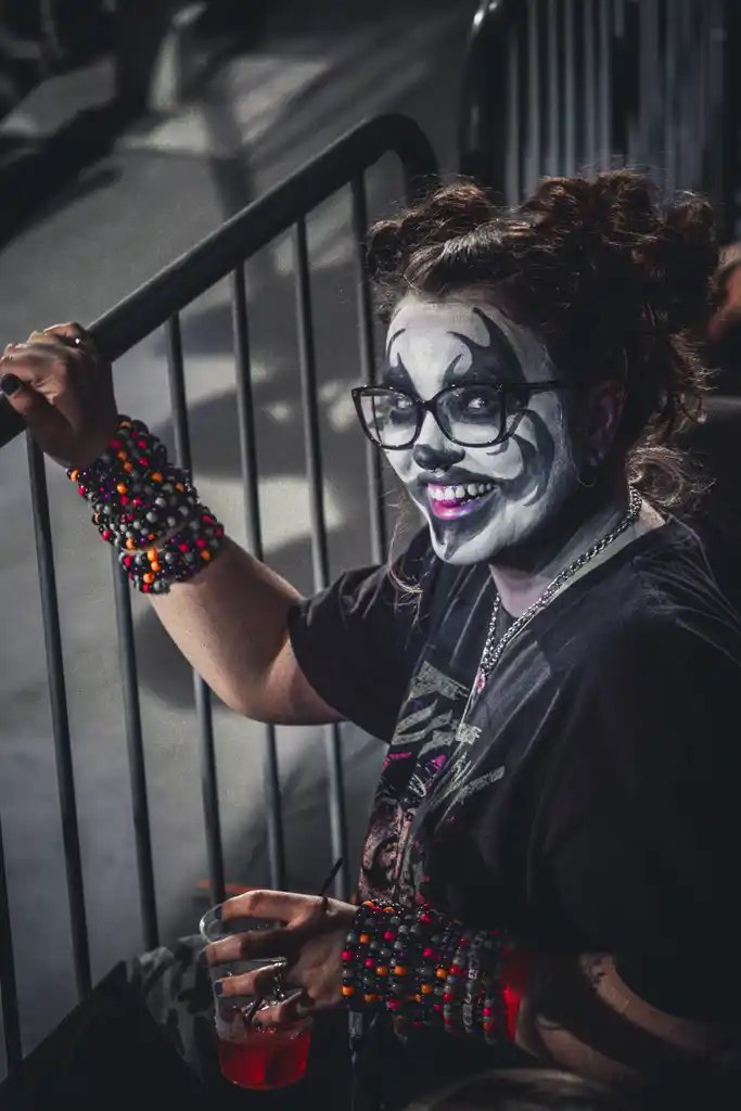 Fan in clown face paint at the barricade