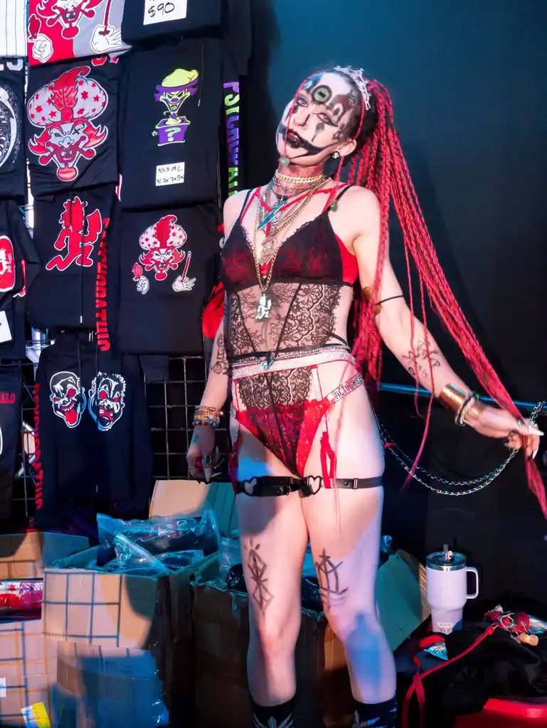 Juggalette in full face paint by the merch wall