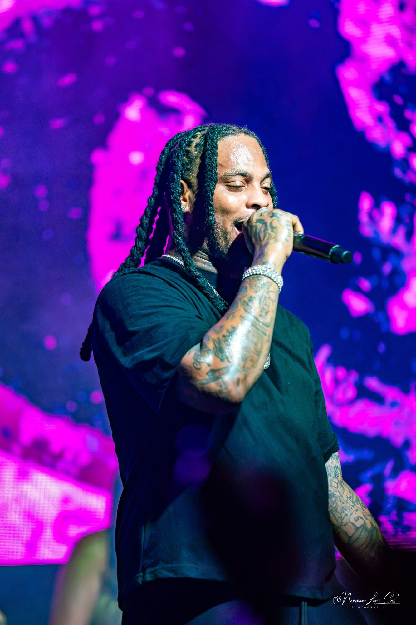 Waka Flocka Flame performing under pink lights at Diamondback Music Hall